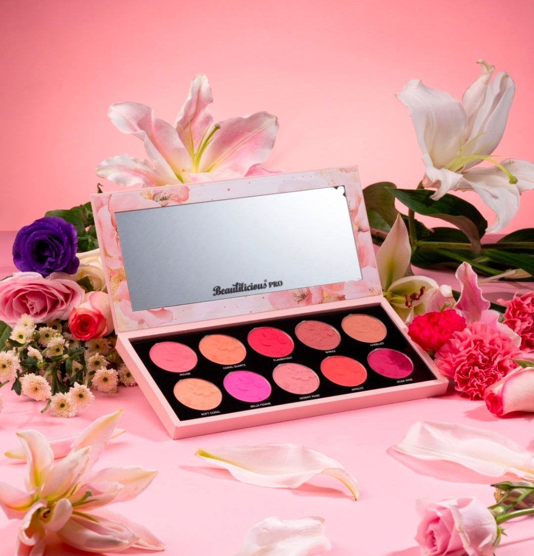 Makeup palette with flowers on a pink background